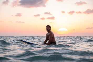 photo of man riding a surf board